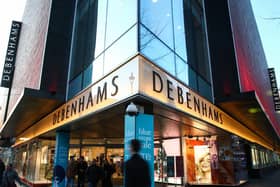 Pedestrians walk past the Debenhams flagship store on Oxford Street