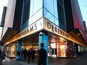 Pedestrians walk past the Debenhams flagship store on Oxford Street