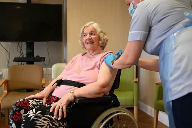 Barbara Ibberson receives a vaccine dose at the Belong Wigan care home