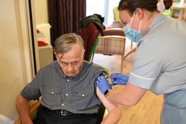 Gordon Winnard, 72, receives a vaccine dose at Belong Wigan