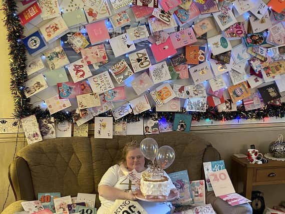 Christine Lillis surrounded by 40th birthday cards at her Newtown home