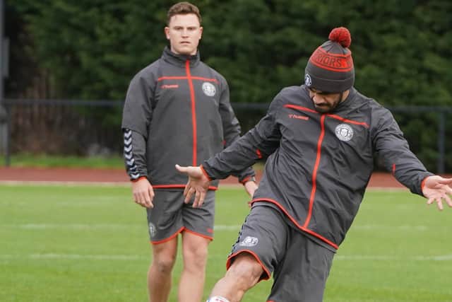 Jai Field watches Thomas Leuluai kick the ball during a training session at Robin Park
