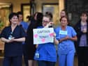 A nurse at Aintree University Hospital sheds a tear and as she pays tribute to super fundraiser Captain Tom Moore during the "Clap for Our Carers" and the NHS on April 16, 2020