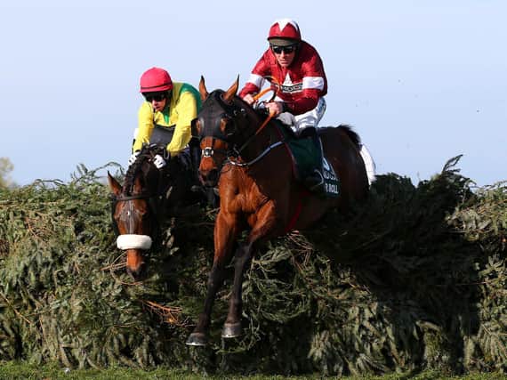 Davy Russell riding Tiger Roll clears the final fence as he races to victory in the 2019 Randox Health Grand National at Aintree