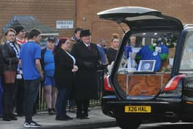 Mourners wore blue or sports kits to pay their respects