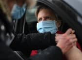 Health workers administer a Covid-19 vaccine at a drive through vaccination centre
