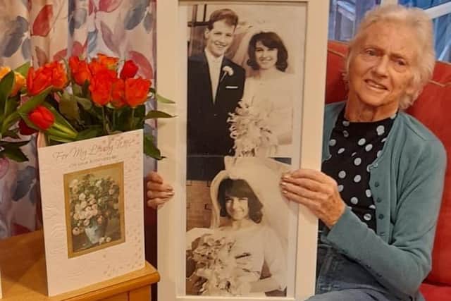 Eileen Crookall at Belong Wigan with photos of her and Barry's wedding day