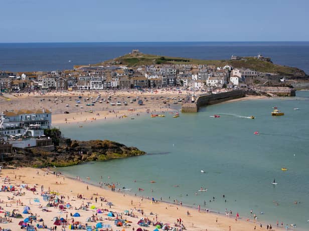 Visitors and holidaymakers enjoy the fine weather as they gather on the beaches and the harbour on August 4, 2014 in St Ives, Cornwall