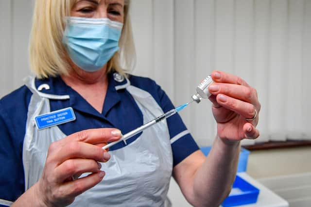 A nurse prepares a dose of a Covid-19 vaccine