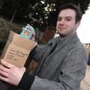 Wigan Today reporter Liam Soutar boxes up some Heinz Baked Beans for Jacob Rees-Mogg