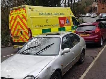 An ambulance attempts to squeeze past parked cars in Danes Avenue