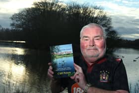 Cliff Peters at Bickershaw Country Park with his book of walks