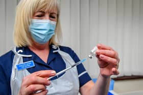 A nurse giving a dose of a Covid-19 vaccine