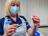 A nurse giving a dose of a Covid-19 vaccine