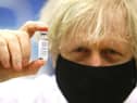 Prime Minister Boris Johnson holding a vial of the Oxford/Astra Zeneca Covid-19 vaccine on February 17, 2021 (Picture: Geoff Caddick/PA Wire)