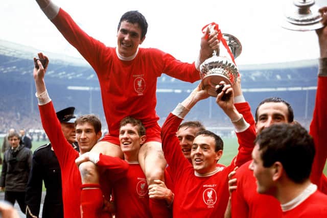 Liverpool captain Ron Yeats (top) holds on to the FA Cup as he is hoisted aloft by his jubilant teammates after winning the trophy in 1965: (l-r) Geoff Strong, Yeats, Wilf Stevenson, Peter Thompson, Ian St John, Gerry Byrne, Ian Callaghan