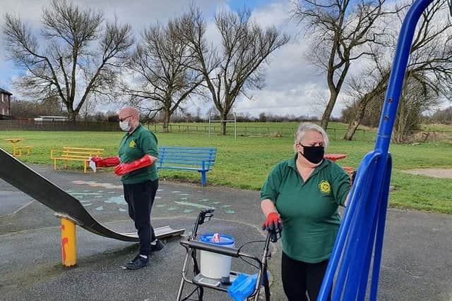 Volunteers gets spraying with anti-bacterial cleaning products in public spaces