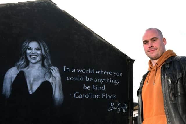Scott Wilcock with his mural of Caroline Flack in Ashton