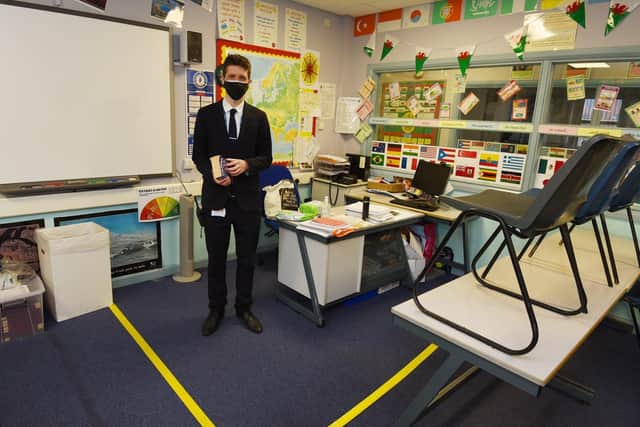Assistant head Paul Blakemore in a classroom with a box for the teacher
