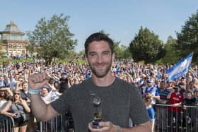 Will Grigg celebrates in Mesnes Park with the Latics fans