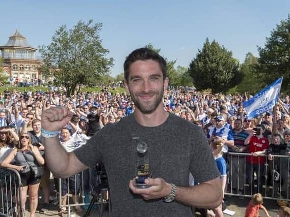 Will Grigg celebrates in Mesnes Park with the Latics fans