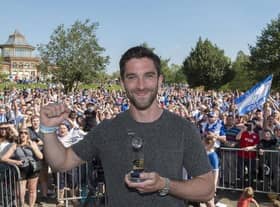 Will Grigg celebrates in Mesnes Park with the Latics fans