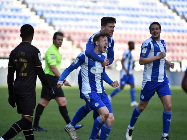 George Johnston celebrates opening the scoring against MK Dons