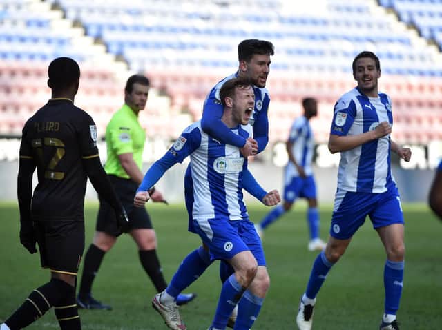 George Johnston celebrates opening the scoring against MK Dons