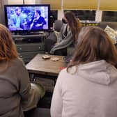 People watching a televised conversation between Prince Harry with his wife Meghan Markle and US host Oprah Winfrey