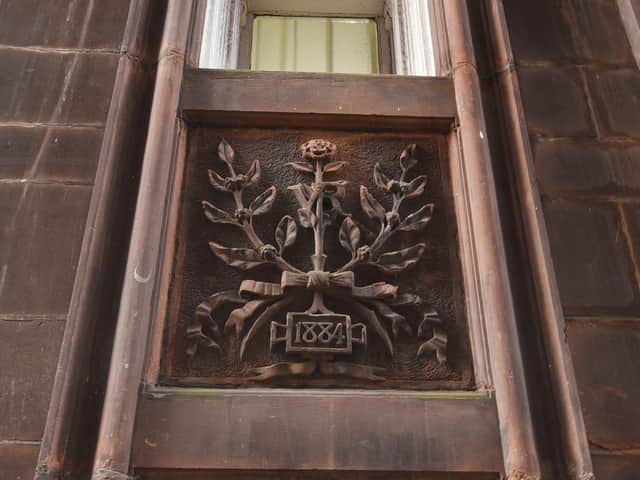 Ornate stonework commemorates the building's construction in the Victorian era