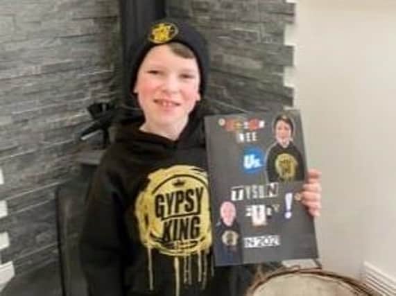 Ethan Lee with his book about Tyson Fury