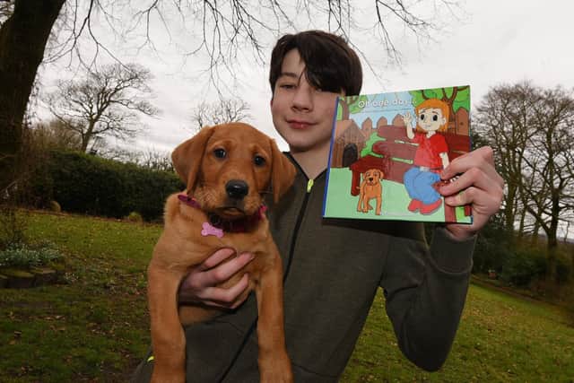 Sam Grant with his children's book and puppy Honey