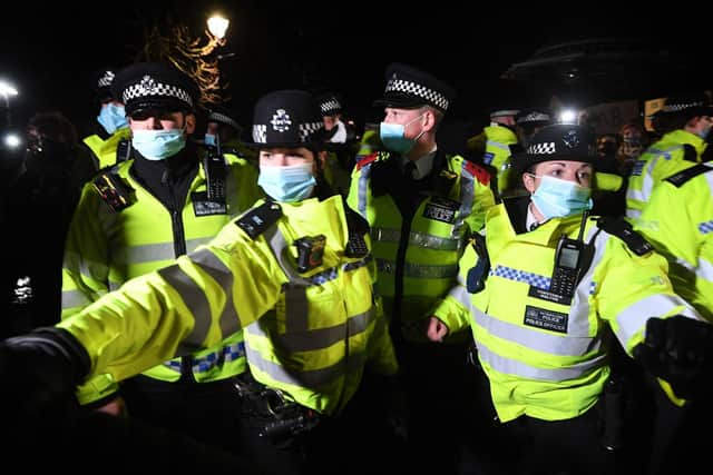 Police officers clash with people as they form a gathering in Clapham Common, London, after the Reclaim These Streets vigil for Sarah Everard was officially cancelled