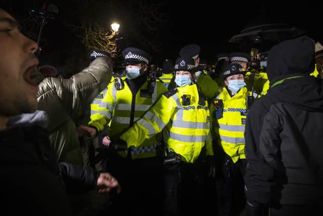 Police officers clash with people as they form a gathering in Clapham Common, London, after the Reclaim These Streets vigil for Sarah Everard was officially cancelled