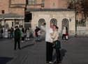 Tourists take a selfie in front of the Hagia Sophia Grand Mosque during a national weekend coronavirus lockdown on December 06, 2020, in Istanbul, Turkey