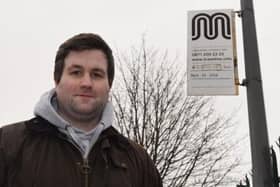 Coun Adam Marsh at a bus stop that is not in use on Bradley Lane, Standish