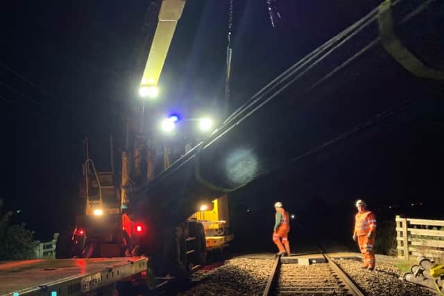 Rail mounted crane installing pipes to pump away Burscough flood water. A survey is to begin in May 2021 in a bid to discover why the rail line and the town, in West Lancashire, are so badly affected by flooding. Picture courtesy Network Rail