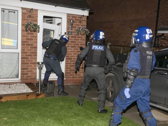 Police executing a warrant at a Wigan home on Tuesday