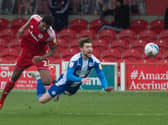 Callum Lang is sent tumbling at Accrington