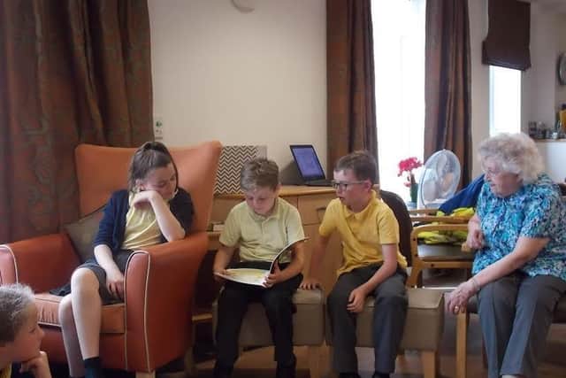 Primary school children share their love of reading at Belong care village