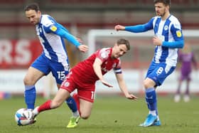 Sean McConville of Accrington Stanley is challenged by Dan Gardner of Wigan Athletic during the Sky Bet League One match between Accrington Stanley and Wigan Athletic at The Crown Ground on March 20, 2021 in Accrington, England.