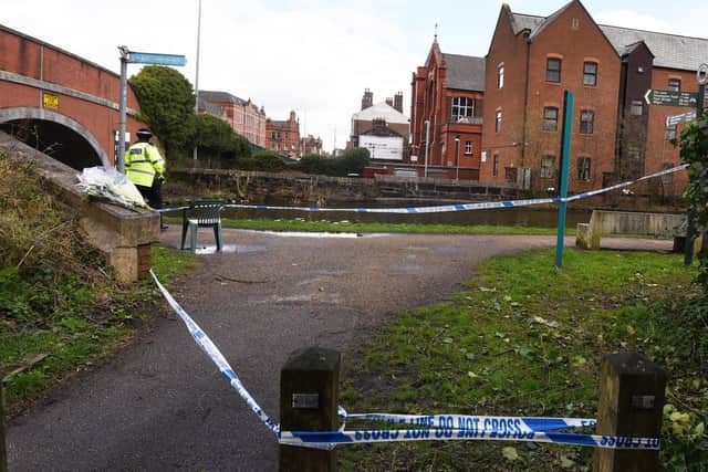 Police tape seals off an area of canal where a man's body was found
