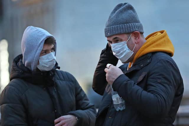 People wearing face masks as the coronavirus spreads across the UK