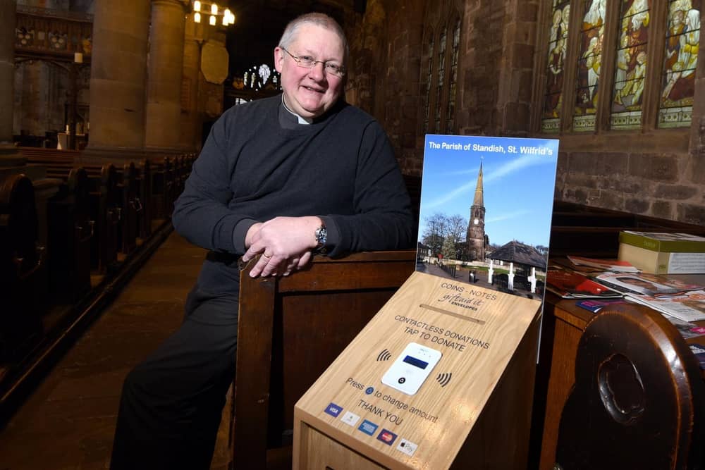 Reverend Andrew Holliday with the payment machine