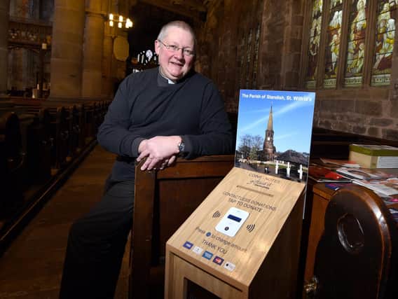 Reverend Andrew Holliday with the payment machine