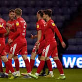 The Latics players celebrate Will Keane's goal at Boundary Park that put the visitors 2-0 up