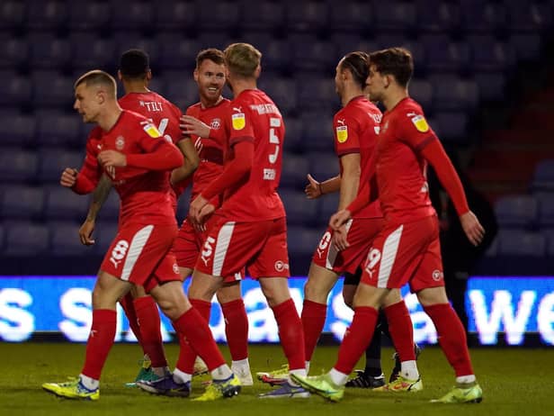The Latics players celebrate Will Keane's goal at Boundary Park that put the visitors 2-0 up