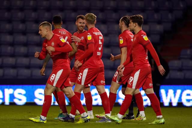 The Latics players celebrate Will Keane's goal at Boundary Park that put the visitors 2-0 up