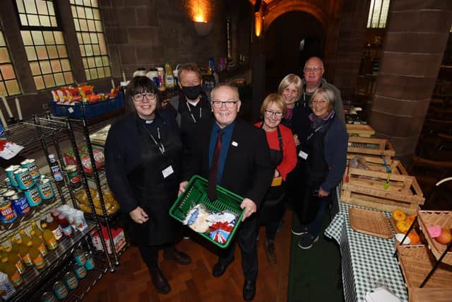 Coun George Davies, centre, shows support and joins Rev Sandra Jones, left, with volunteers at JEDS food pantry, at St Stephen’s church, Whelley