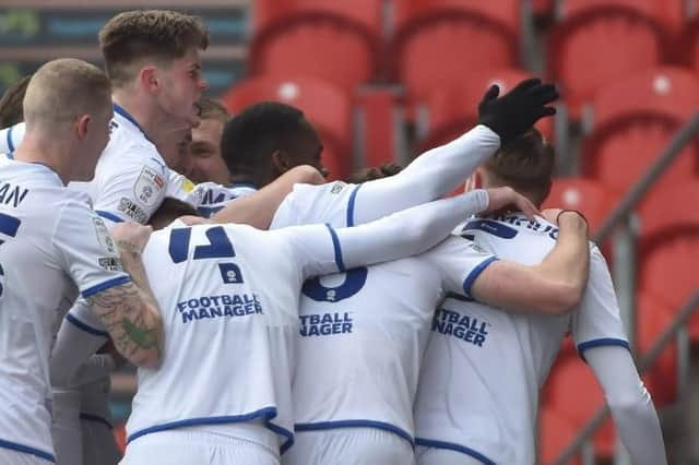 Max Power is mobbed after opening the scoring for Latics